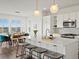 Contemporary kitchen featuring a large island, pendant lighting, and an adjacent dining area at 14710 Domino Dr, Parker, CO 80134