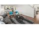 Open-concept living space with hardwood floors and modern furniture, kitchen in the background at 14710 Domino Dr, Parker, CO 80134