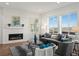 Bright and airy living room featuring a fireplace, large windows, and sleek furniture at 14710 Domino Dr, Parker, CO 80134