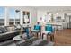 Bright, open-concept living room with hardwood floors and a view of the modern kitchen at 14710 Domino Dr, Parker, CO 80134