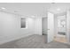 Bright basement bedroom with neutral walls, plush gray carpet, and easy bathroom access at 9230 Aspen Dr, Thornton, CO 80229