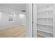 Bright hallway leading to a bedroom with neutral walls and light wood flooring throughout at 9230 Aspen Dr, Thornton, CO 80229