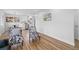 Bright living room flowing into kitchen, with hardwood floors and stylish furnishings creating an inviting and modern living space at 9230 Aspen Dr, Thornton, CO 80229