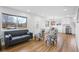 Bright, open-concept living room showcasing hardwood floors, and seamless flow into dining and kitchen areas for modern living at 9230 Aspen Dr, Thornton, CO 80229
