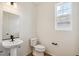 Powder bathroom with a sleek pedestal sink and a modern black faucet at 6207 E 155Th Pl, Brighton, CO 80602