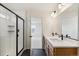 Bathroom boasting double sinks, a walk-in shower with glass door, and modern fixtures at 6207 E 155Th Pl, Brighton, CO 80602