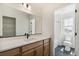 Well-lit bathroom featuring a vanity with dual sinks and a separate toilet and shower area at 6207 E 155Th Pl, Brighton, CO 80602