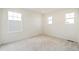 Bedroom with large windows providing ample natural light and plush carpet at 6207 E 155Th Pl, Brighton, CO 80602