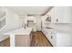 Modern kitchen features an island with breakfast bar, stainless steel appliances, and white cabinets at 6207 E 155Th Pl, Brighton, CO 80602