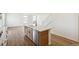 Kitchen island with stainless steel dishwasher and sink overlooking the hardwood floor at 6207 E 155Th Pl, Brighton, CO 80602