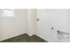 Functional laundry room featuring dark tile flooring and utility hookups at 6207 E 155Th Pl, Brighton, CO 80602