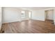 Bright, open living room with wood floors, white walls, and natural light from large windows at 6207 E 155Th Pl, Brighton, CO 80602
