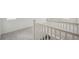 View of the top of the staircase with white railings, leading to bedrooms with carpets at 6207 E 155Th Pl, Brighton, CO 80602