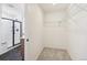 Bright walk-in closet with a wire shelving system, open doorway to bathroom with shower at 6207 E 155Th Pl, Brighton, CO 80602