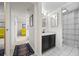 Bathroom features a vanity with a dark cabinet, white tile floors, and a shower with a curtain at 777 N Washington St # 304, Denver, CO 80203