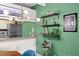 Dining area showcasing a modern chandelier, granite counters, floating shelves, and green accent walls at 777 N Washington St # 304, Denver, CO 80203
