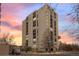 A tall building with symmetrical architecture rises with balconies and a crosswalk in front at 777 N Washington St # 304, Denver, CO 80203