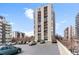 View of the high-rise building with parking in front on a sunny day at 777 N Washington St # 304, Denver, CO 80203