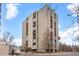 A tall building with symmetrical architecture rises with balconies and a crosswalk in front at 777 N Washington St # 304, Denver, CO 80203