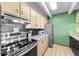 Kitchen featuring granite countertops, tile floors, a stainless steel range, and green walls at 777 N Washington St # 304, Denver, CO 80203