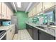 Updated kitchen with wood cabinets, stylish countertops, stainless steel appliances, and tile floor at 777 N Washington St # 304, Denver, CO 80203