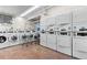 Bright laundry room featuring several washing machines and dryers for resident convenience at 777 N Washington St # 304, Denver, CO 80203