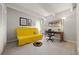Cozy living room with a gray carpet, yellow sofa bed, and a desk area with a floor lamp at 777 N Washington St # 304, Denver, CO 80203