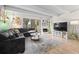 Comfortable living room with sleek sofa, fireplace, large TV and walkout balcony at 777 N Washington St # 304, Denver, CO 80203