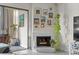 Cozy living room featuring a white painted brick fireplace and sliding doors to the balcony at 777 N Washington St # 304, Denver, CO 80203