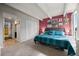 Well-lit main bedroom with carpet floors, an accent wall, and large closet at 777 N Washington St # 304, Denver, CO 80203