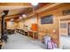 Finished area inside barn, with knotty pine, workbenches, and a wood stove at 33844 Oriole Ct, Elizabeth, CO 80107