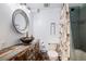 Rustic bathroom featuring a vessel sink, unique vanity, and tiled shower at 33844 Oriole Ct, Elizabeth, CO 80107
