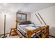 Quaint bedroom with a rustic wooden bed frame, decorative skis, and a cozy, mountain-inspired aesthetic at 33844 Oriole Ct, Elizabeth, CO 80107