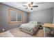 Bedroom with a bed, desk, and window providing natural light, creating a functional and comfortable space at 33844 Oriole Ct, Elizabeth, CO 80107