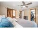 Comfortable bedroom with a rustic sliding barn door leading to the ensuite bathroom and closet at 33844 Oriole Ct, Elizabeth, CO 80107
