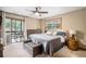 Cozy bedroom featuring a comfortable bed, wood-framed windows, and a sliding glass door to a balcony at 33844 Oriole Ct, Elizabeth, CO 80107
