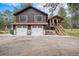 Charming two-story home featuring a two-car garage and detached covered porch with stairs at 33844 Oriole Ct, Elizabeth, CO 80107