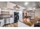 Bright open kitchen featuring white cabinets and stainless steel appliances at 33844 Oriole Ct, Elizabeth, CO 80107
