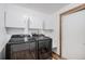 Convenient laundry area with modern machines, overhead cabinets, and utility sink at 33844 Oriole Ct, Elizabeth, CO 80107