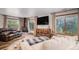 Cozy living room featuring a stone fireplace, hardwood floors, and comfortable seating at 33844 Oriole Ct, Elizabeth, CO 80107