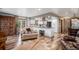 Open-concept living room featuring hardwood floors and cozy seating area at 33844 Oriole Ct, Elizabeth, CO 80107