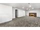 Large open finished basement with a brick fireplace and neutral carpet creates a versatile living space at 6336 W 71St Pl, Arvada, CO 80003