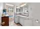 Well-lit bathroom featuring ample cabinet space and access to a bathtub at 6336 W 71St Pl, Arvada, CO 80003