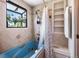 Updated bathroom with modern shower head and built-in shelving at 6336 W 71St Pl, Arvada, CO 80003