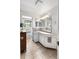 Bright bathroom featuring large cabinet space and views of the bathtub at 6336 W 71St Pl, Arvada, CO 80003