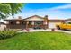 Charming ranch-style home with brick facade, red shutters and well-manicured lawn at 6336 W 71St Pl, Arvada, CO 80003