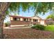 Charming ranch-style home with brick facade, red shutters and landscaped front yard at 6336 W 71St Pl, Arvada, CO 80003