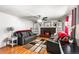 Inviting living room with fireplace, hardwood floors, and comfortable seating at 6336 W 71St Pl, Arvada, CO 80003