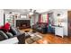 Cozy living room with a fireplace, built-in shelves and hardwood floors at 6336 W 71St Pl, Arvada, CO 80003