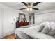 Spacious main bedroom featuring wood floors, ceiling fan, and closet at 6336 W 71St Pl, Arvada, CO 80003